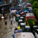 People wading through floodwaters in Dhaka after record rainfall during the Bangladesh Flood 2026, causing widespread flooding, transport disruption, and loss of lives.