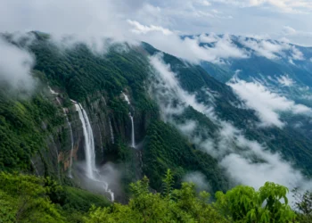 Meghalaya Tourism showcasing mist-covered mountains, lush green forests, cascading waterfalls, and scenic valleys in the Land of Clouds.