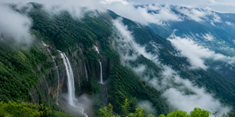 Meghalaya Tourism showcasing mist-covered mountains, lush green forests, cascading waterfalls, and scenic valleys in the Land of Clouds.