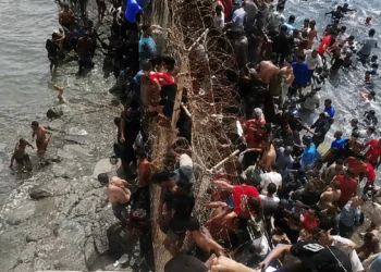Spain Morocco Border Crisis: Thousands of migrants attempt to swim across the Spain-Morocco border near Ceuta as security forces respond amid a deadly migration crisis.