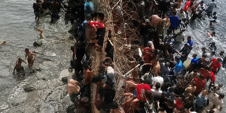 Spain Morocco Border Crisis: Thousands of migrants attempt to swim across the Spain-Morocco border near Ceuta as security forces respond amid a deadly migration crisis.