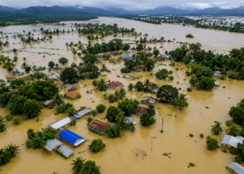 Assam Floods 2026: Floodwaters inundating villages and agricultural land in Assam as the overflowing Brahmaputra River and heavy monsoon rainfall trigger widespread devastation across the state.