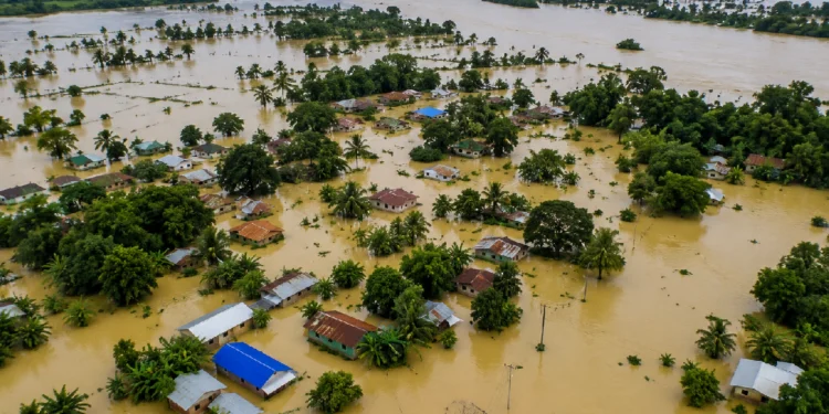 Assam Floods 2026: Floodwaters inundating villages and agricultural land in Assam as the overflowing Brahmaputra River and heavy monsoon rainfall trigger widespread devastation across the state.