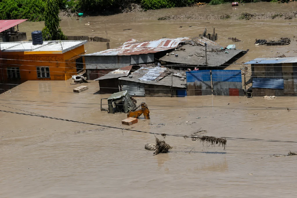 Nepal Flash Flood near the Tibet border with damaged roads, flooded areas and ongoing rescue operations.