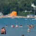 Russia Ukraine Drone Attack: Emergency responders and security personnel at a crowded Russian Black Sea beach after a deadly drone strike that reportedly killed seven people and injured dozens.